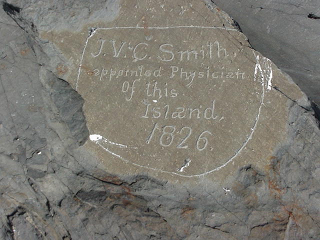 Engraving on white rock reads: J.V.C. Smith, appointed physician of this island. 1826.